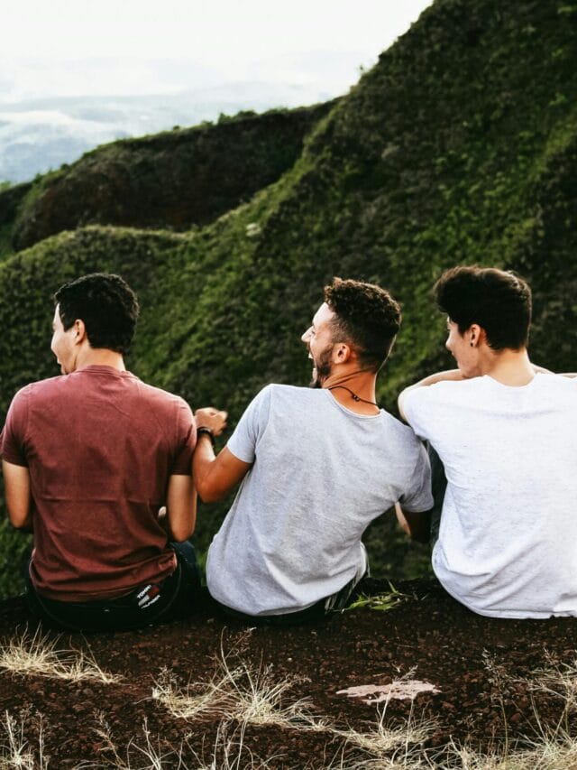 Four friends enjoying a scenic mountain view, symbolizing friendship and adventure.